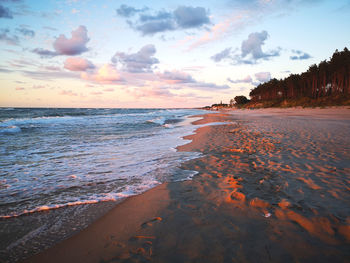 Scenic view of beach against sky during sunset