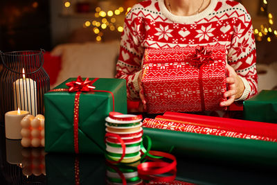 Midsection of woman holding christmas presents