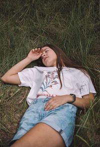 Young woman lying on field