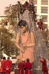 People on tree against sky