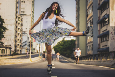 Portrait of young woman riding motorcycle on road