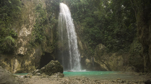 Waterfall in green forest in jungle. beautiful waterfall in the mountains. 