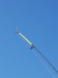 Low angle view of airshow against clear blue sky