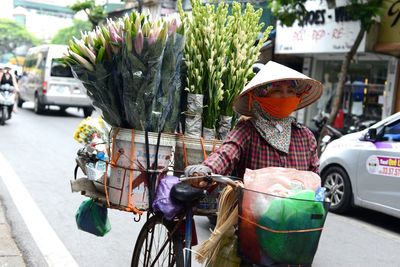 Midsection of man with bicycle in city