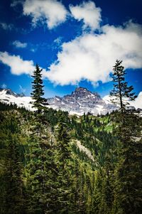 Scenic view of mountains against cloudy sky