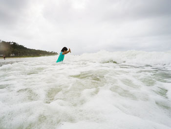 Full length of man in sea against sky