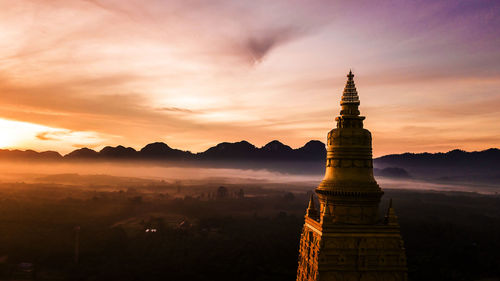 Panoramic view of a building against sky during sunset