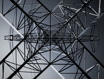 Low angle view of electricity pylon against sky