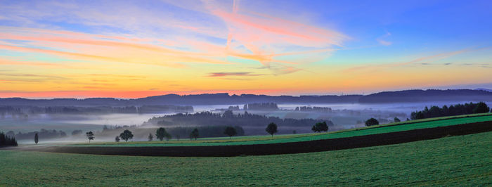 Scenic view of field against sky during sunset