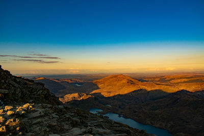 Scenic view of mountains against sky during sunset