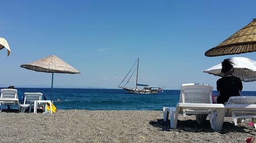 Scenic view of beach against blue sky