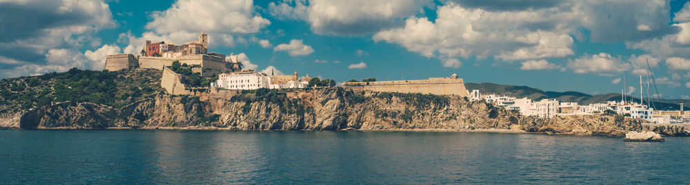 Distant view of fort on mountain in city by sea