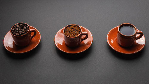 High angle view of coffee cup on table against black background