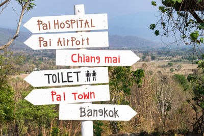 Information sign on landscape against mountains