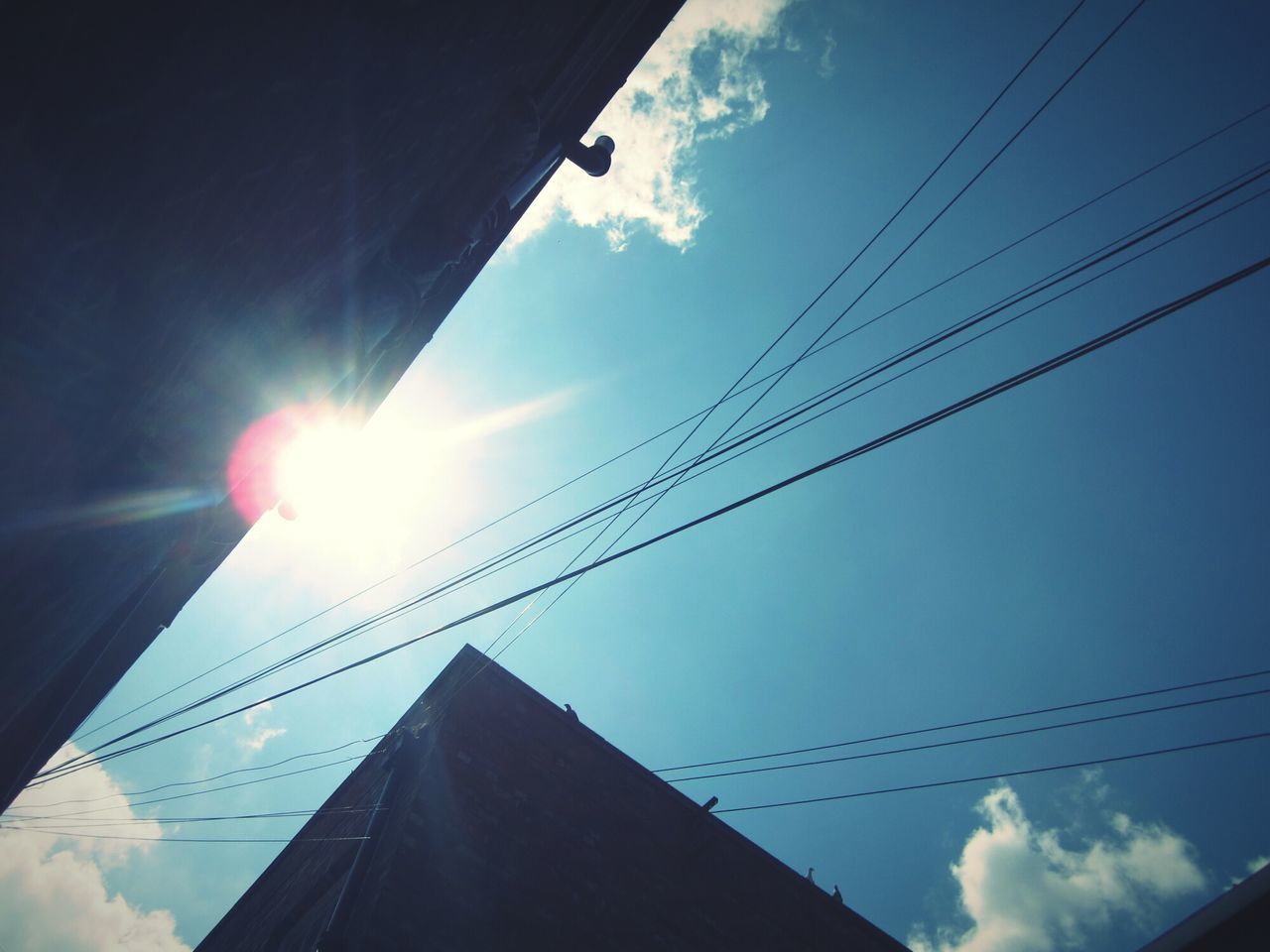 LOW ANGLE VIEW OF POWER LINES AGAINST SKY