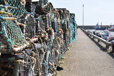 Stack of clothes drying on harbor against sky