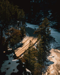 Sunset overlooking mountain road next to frozen river. 