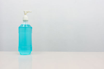 Blue bottle against white background