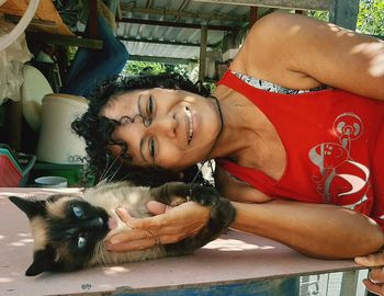 Portrait of smiling young woman with cat
