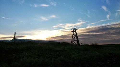 Wind turbines on field at sunset