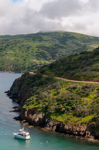 Scenic view of sea and mountains against sky