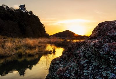 Scenic view of lake against sky during sunset