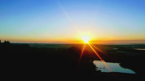 Scenic view of sea against clear sky during sunset