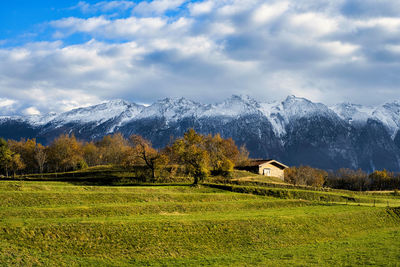 Scenic view of field and mountains against sky