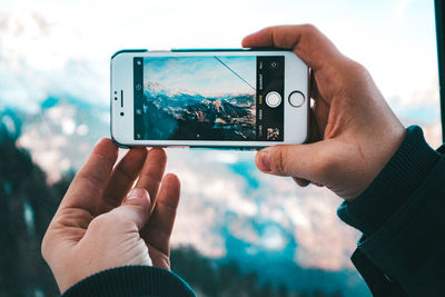 Close-up of person photographing with mobile phone