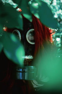 Woman with red hair wearing a soviet union gas mask