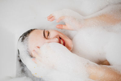 Close-up of young woman with eyes closed in bathroom