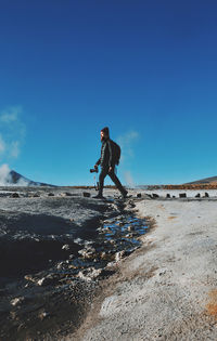 Man walking on arid landscape