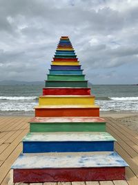 Multi colored umbrellas on beach against sky