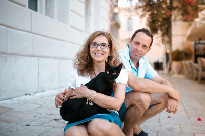 Portrait of happy friends sitting outdoors