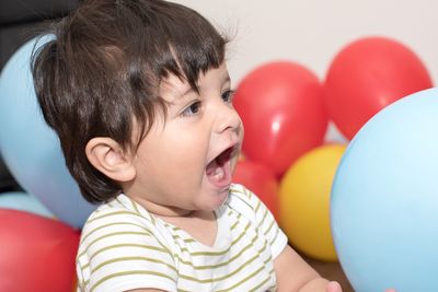 Portrait of smiling boy with balloons