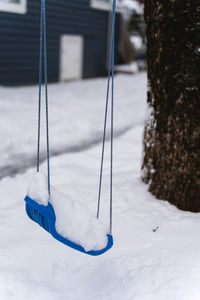 Close-up of swing on snow covered field