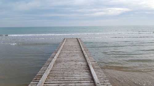 Pier over sea against sky