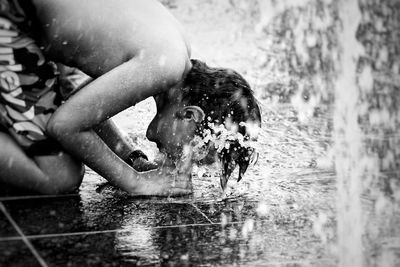 Close-up of shirtless boy swimming in pool