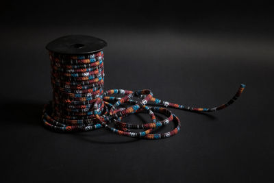 Close-up of illuminated art on table against black background
