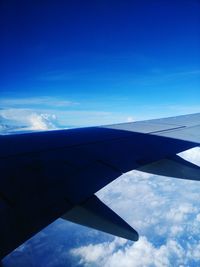 Airplane wing against sky