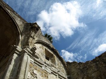 Low angle view of historic building against cloudy sky