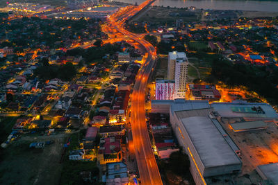 High angle view of illuminated city buildings at night