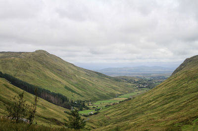 Scenic view of mountains against cloudy sky