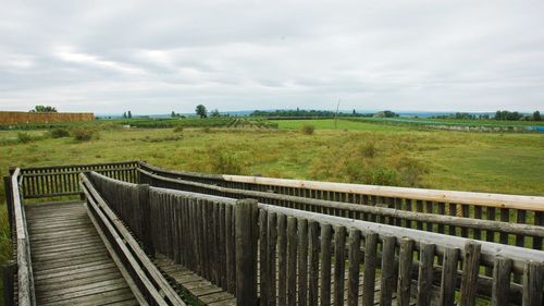 Fence on field against sky