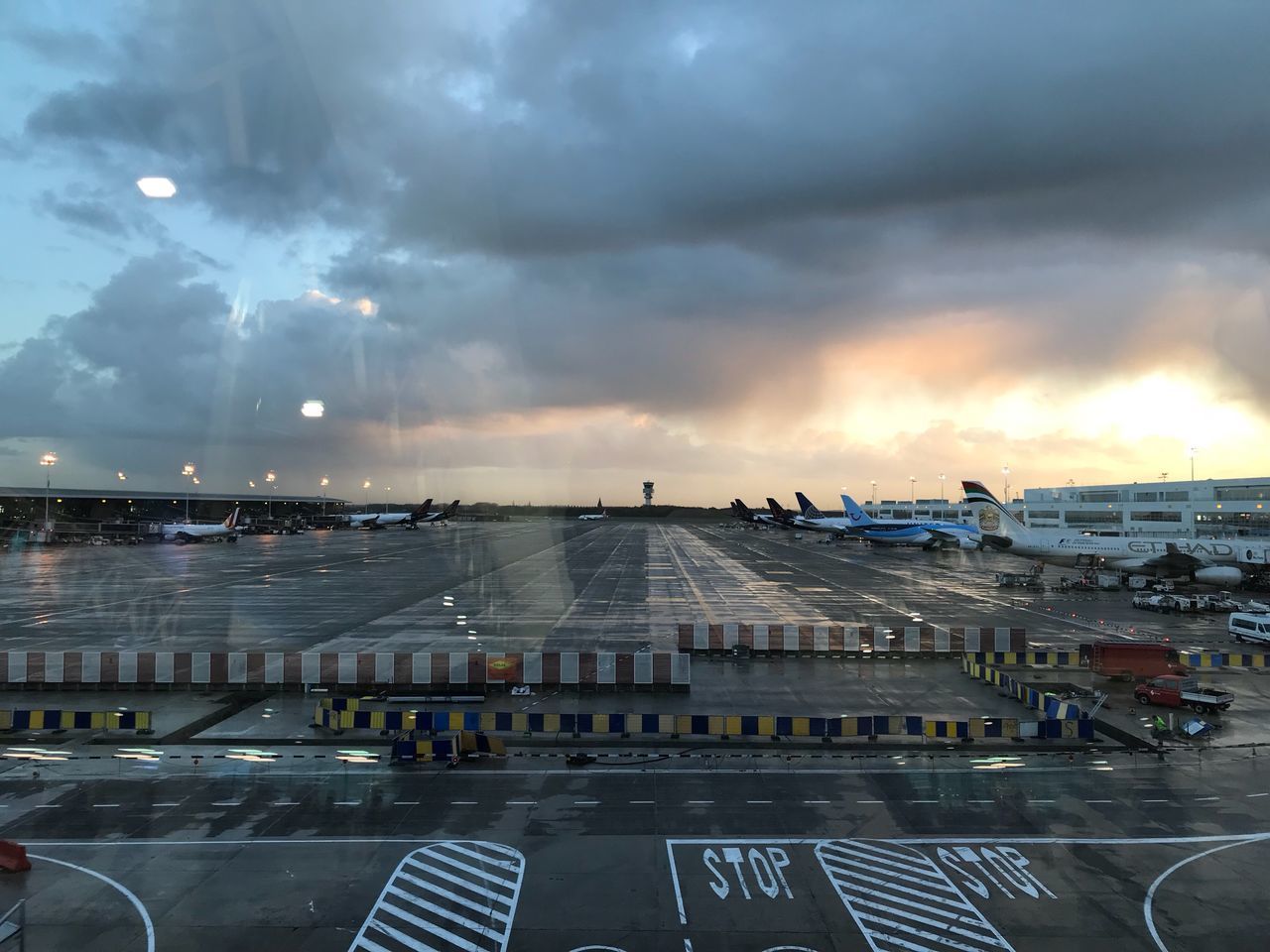 AIRPLANE AT AIRPORT RUNWAY AGAINST SKY