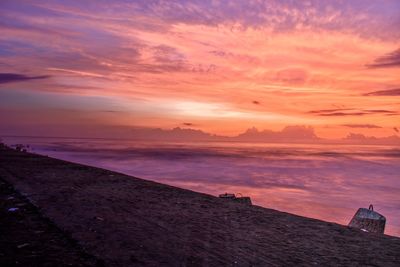 Scenic view of sea against orange sky