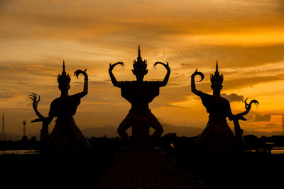 Silhouette of statue at sunset