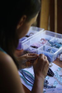 Close-up of woman using sewing 