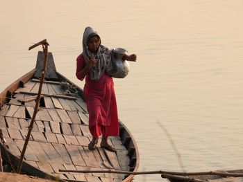 Low angle view of woman standing in boat 