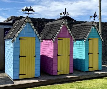 Multi colored houses on beach against sky